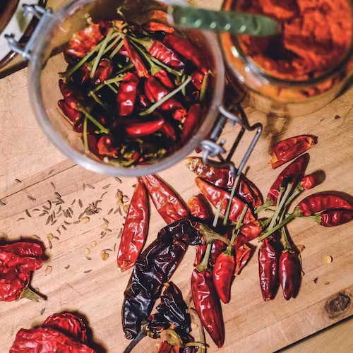 Ingredients for spicy chicken chili, including chicken, beans, and peppers